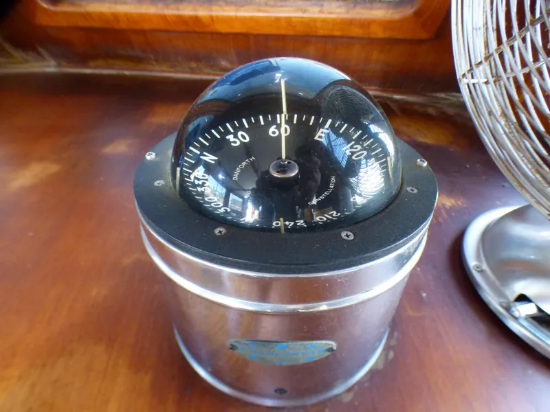 Compass on the 1980 CHB Heritage 42 Trawler's wooden dashboard.