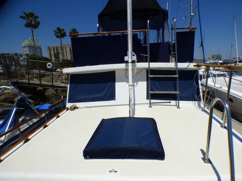 1980 CHB Heritage 42 Trawler deck with blue canvas covers and ladder.