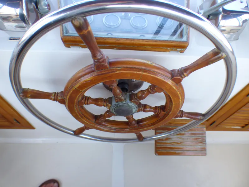 Wooden helm of a 1980 CHB Heritage 42 Trawler boat.