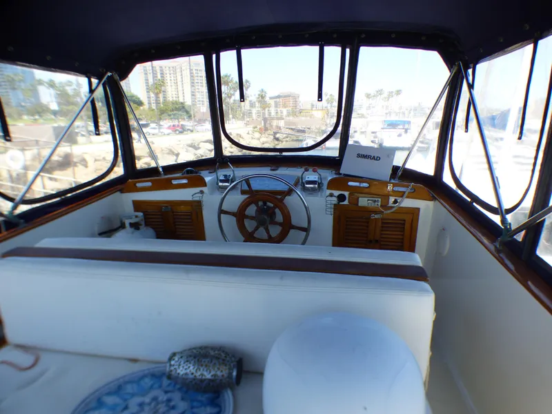 1980 CHB Heritage 42 Trawler helm with panoramic marina view.