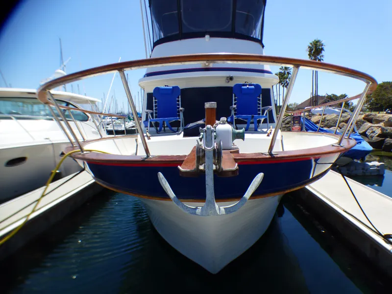 Front view of a 1980 CHB Heritage 42 Trawler docked at a marina.