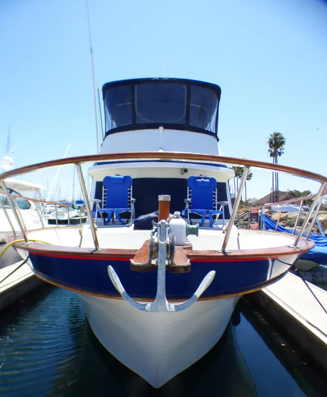1980 CHB Heritage 42 Trawler docked, front view with anchor and deck chairs.