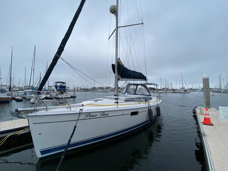 2012 Hunter e36 sailboat docked at marina on a cloudy day.