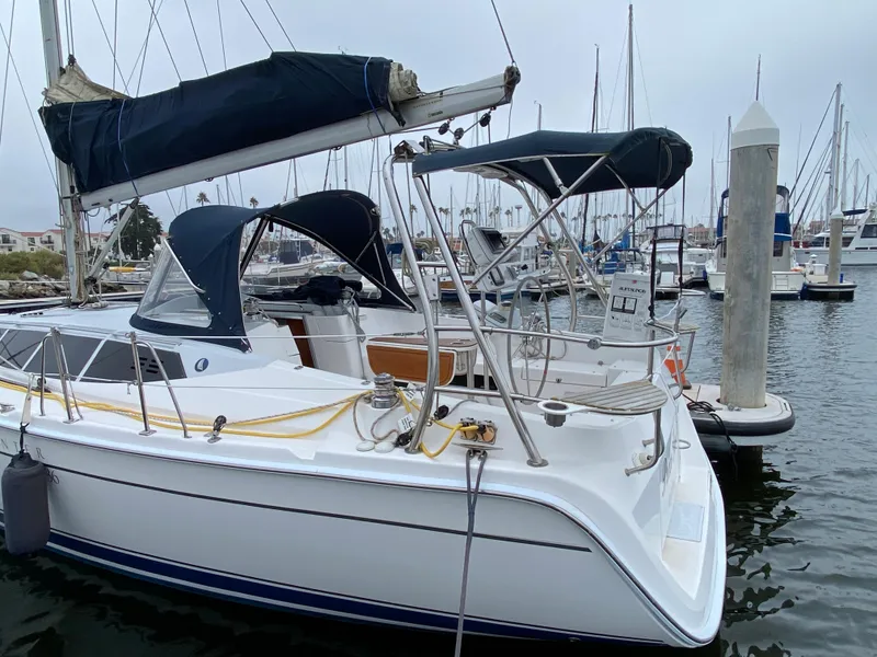 Hunter e36 2012 sailboat docked at marina with other boats in background.