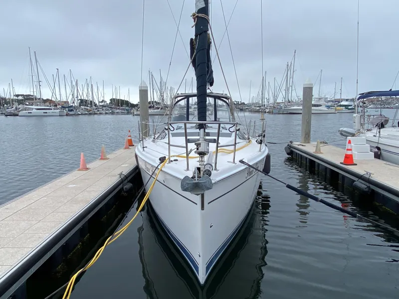 Hunter e36 2012 sailboat docked at marina with other boats in background.