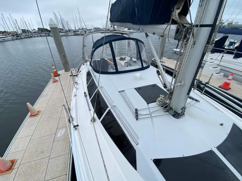 Hunter e36 2012 sailboat docked at marina with other boats in background.