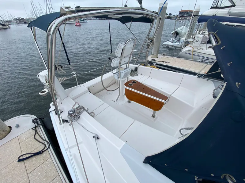 2012 Hunter e36 sailboat docked at marina, featuring spacious cockpit and helm.