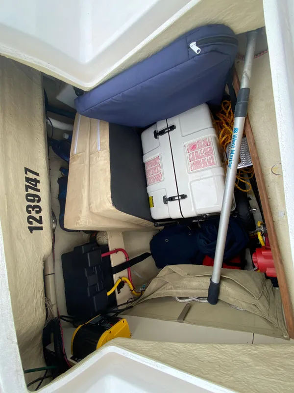 Storage compartment of a 2012 Hunter e36 sailboat with various equipment.
