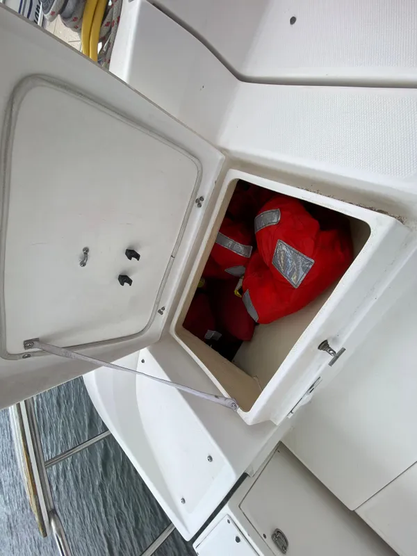 Storage compartment on a 2012 Hunter e36 boat with life jackets inside.