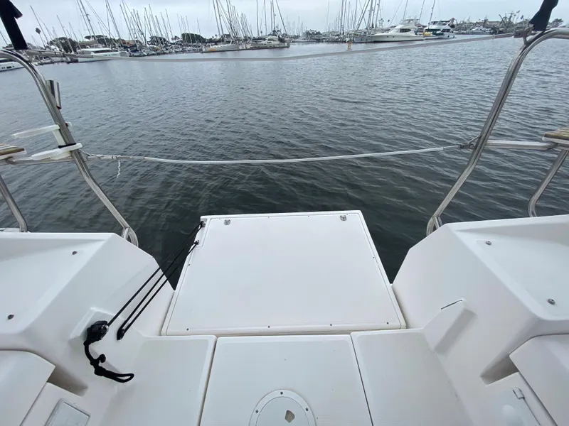 Hunter e36 2012 sailboat stern view at marina with docked boats.