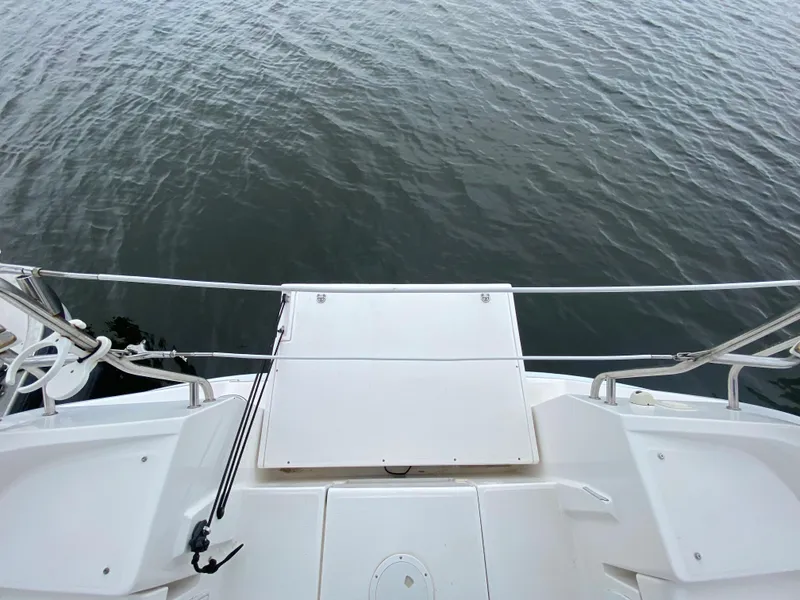 View from the deck of a 2012 Hunter e36 sailboat over calm water.