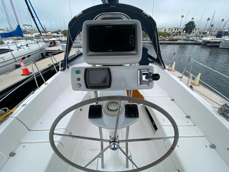Cockpit of a 2012 Hunter e36 sailboat with navigation equipment and steering wheel.