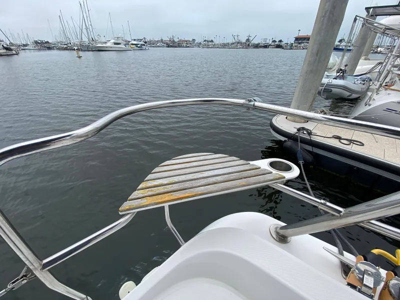 Hunter e36 2012 sailboat at marina with wooden bow platform.