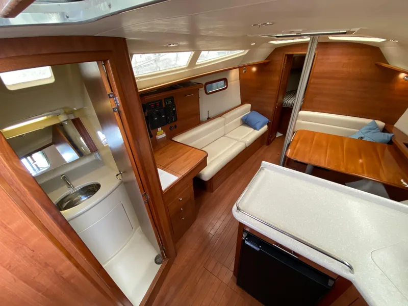 Interior of 2012 Hunter e36 sailboat with modern wood finish and white seating.