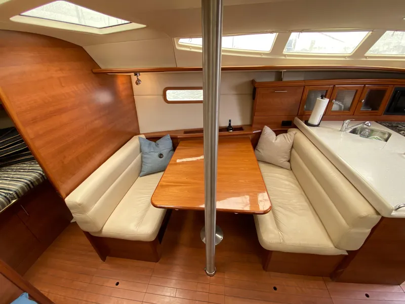 Interior of 2012 Hunter e36 sailboat with dining area and wooden finishes.
