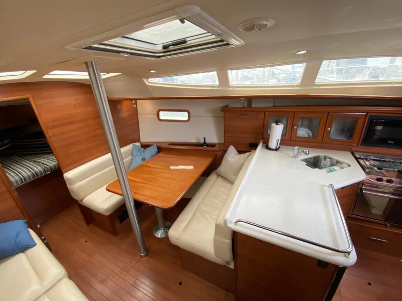 2012 Hunter e36 yacht interior with wood finishes, dining area, and kitchen.