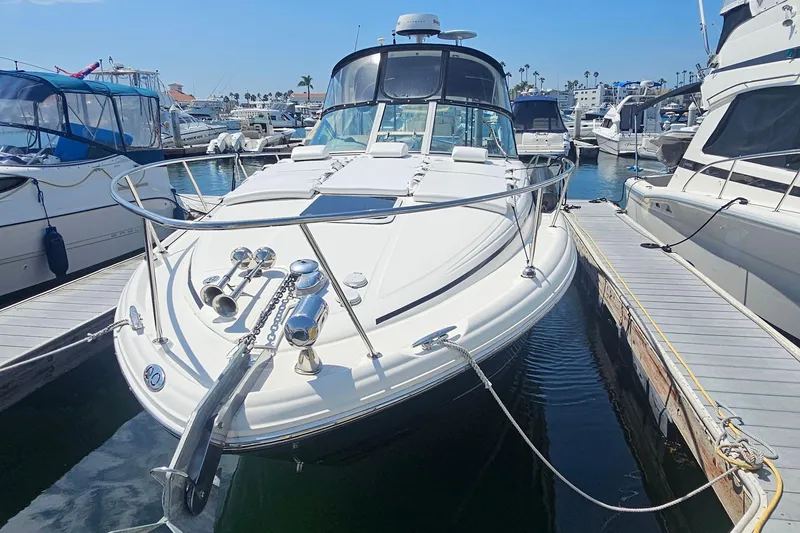 2005 Sea Ray 300 Sundancer docked at marina, surrounded by other boats.