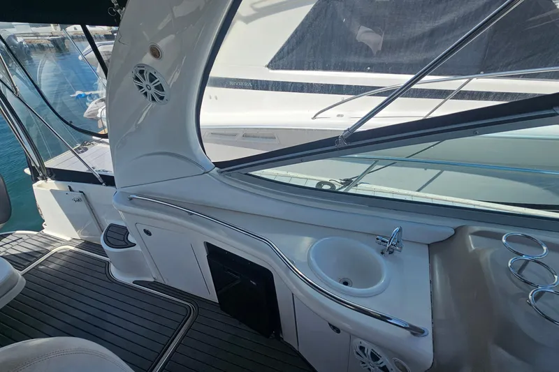 Interior view of 2005 Sea Ray 300 Sundancer yacht with sink and seating area.