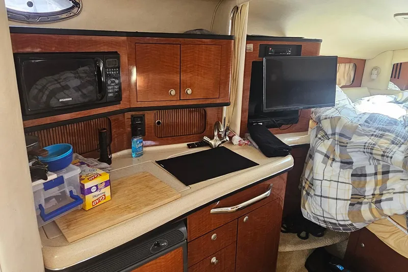 2005 Sea Ray 300 Sundancer cabin interior with kitchenette and bed.