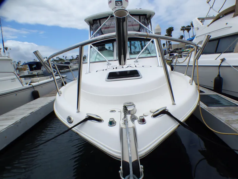 2004 Robalo R265 Walkaround boat docked at marina, front view.