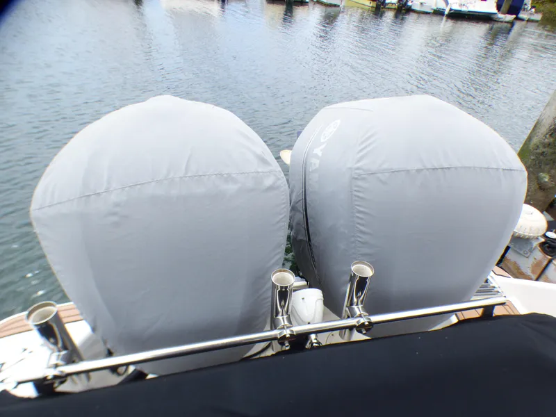 2004 Robalo R265 Walkaround with covered dual outboard motors at a dock.