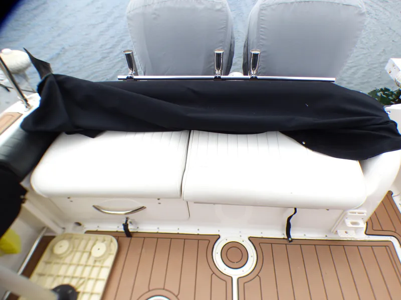 2004 Robalo R265 Walkaround boat interior with cushioned seating and protective cover.