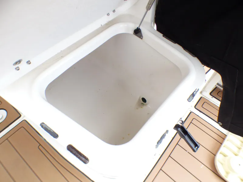 2004 Robalo R265 Walkaround boat storage compartment with open lid.
