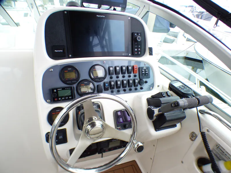 2004 Robalo R265 Walkaround boat dashboard with steering wheel and control panel.