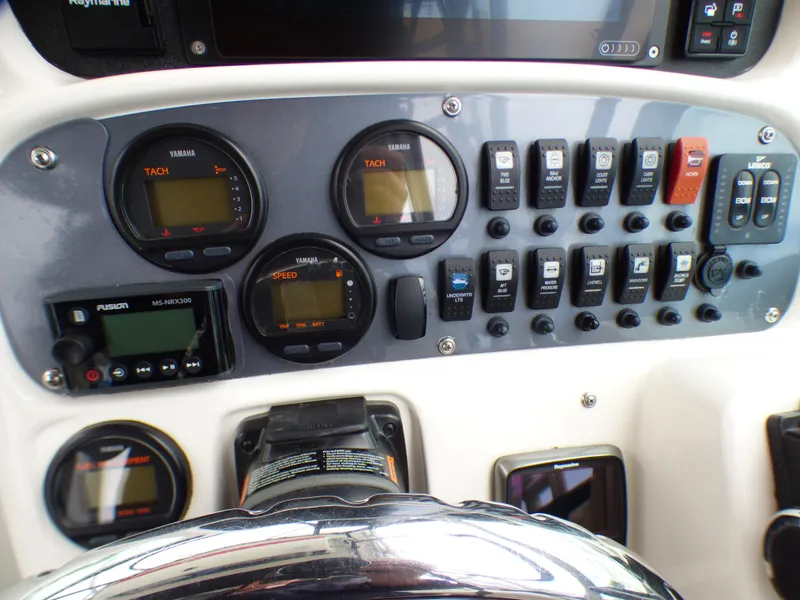 Control panel of a 2004 Robalo R265 Walkaround boat with gauges and switches.