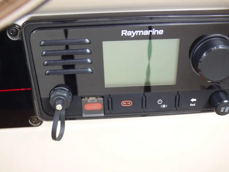 Raymarine marine radio on 2004 Robalo R265 Walkaround boat dashboard.