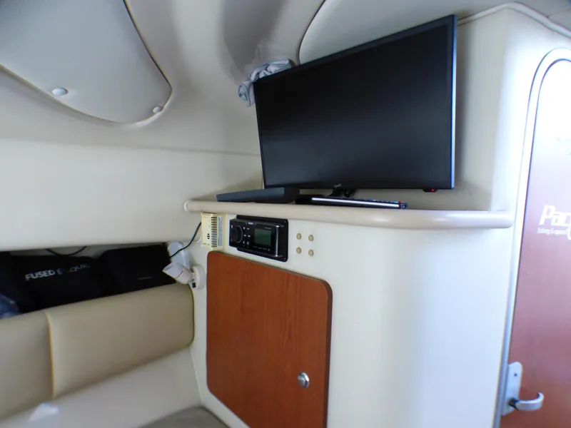 2004 Robalo R265 Walkaround cabin interior with TV and storage cabinet.