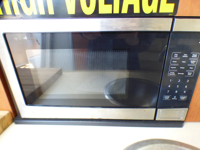 Microwave oven inside a 2004 Robalo R265 Walkaround boat kitchen area.