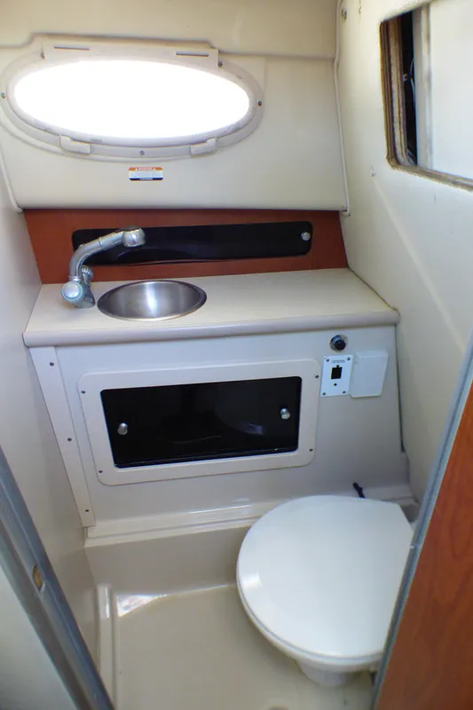2004 Robalo R265 Walkaround boat bathroom with sink and toilet.