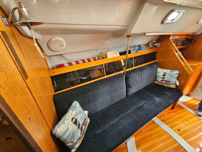 Interior of a 1988 Hunter Legend 35 yacht with blue couch.