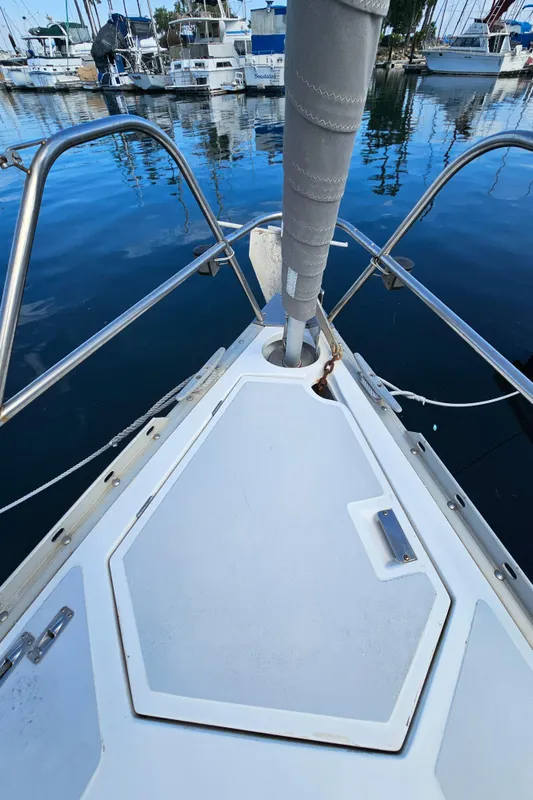Bow of a 1988 Hunter Legend 35 sailboat in harbor.
