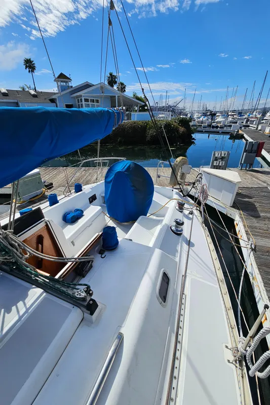 1988 Hunter Legend 35 sailboat docked, blue sky.