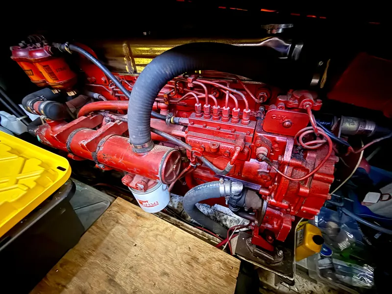 1986 Kha Shing Nautique engine, vibrant red, detailed components, in a workshop setting.