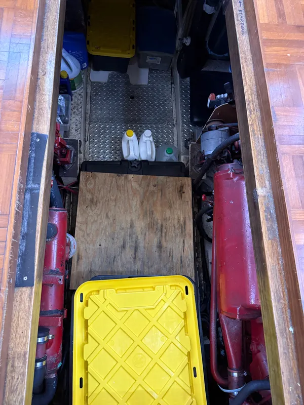 Engine room of 1986 Kha Shing Nautique with storage containers and equipment.