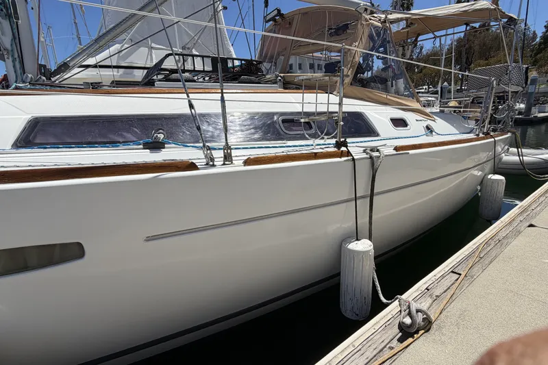 2010 Beneteau Oceanis 37 sailboat docked at marina, side view.