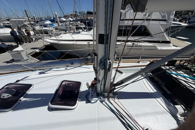 Beneteau Oceanis 37 sailboat deck, 2010 model, docked in a marina with other boats.
