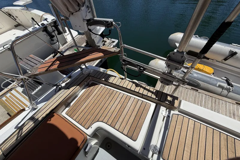 Beneteau Oceanis 37 yacht deck, 2010 model, featuring teak flooring and docked inflatable boat.