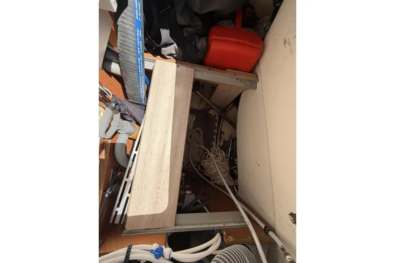 Interior storage area of a 2010 Beneteau Oceanis 37 sailboat, featuring ropes and equipment.