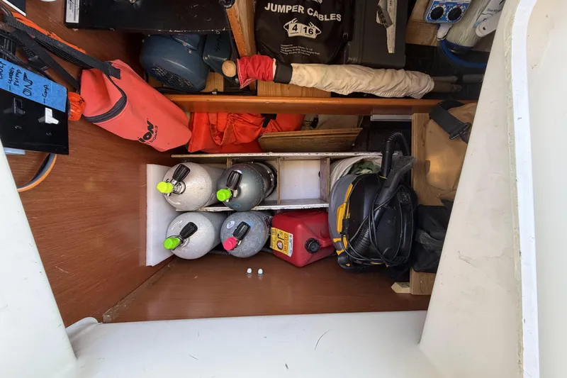 Storage compartment on a 2010 Beneteau Oceanis 37 sailboat with various equipment and supplies.