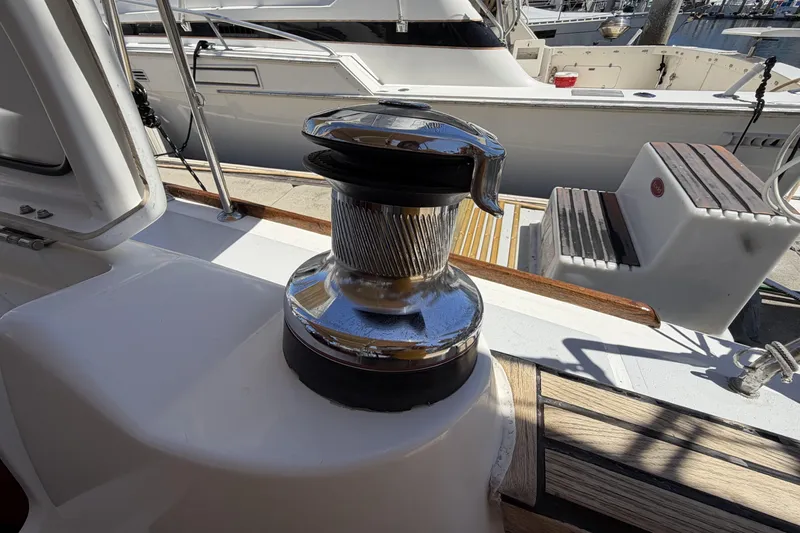 Winch on 2010 Beneteau Oceanis 37 sailboat deck, docked at marina.