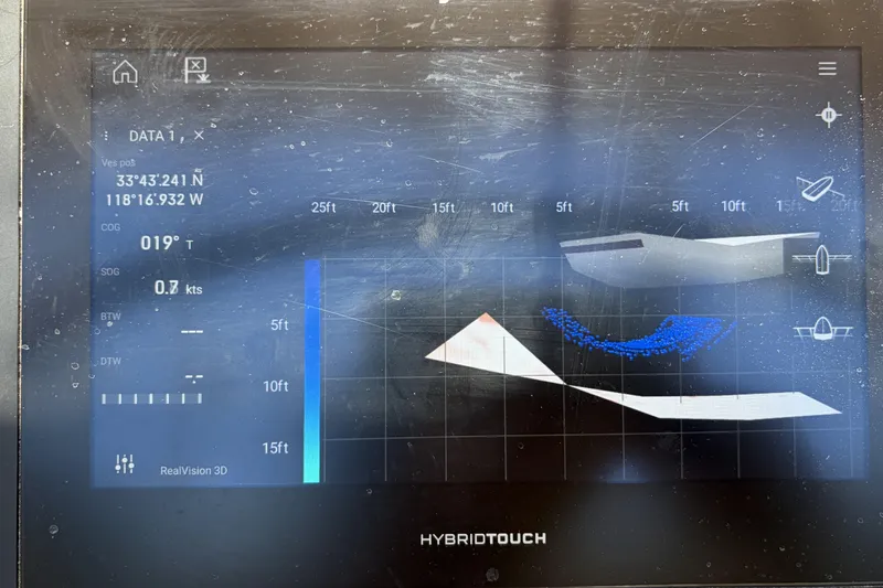 Navigation display on a 2010 Beneteau Oceanis 37 sailboat, showing coordinates and depth data.