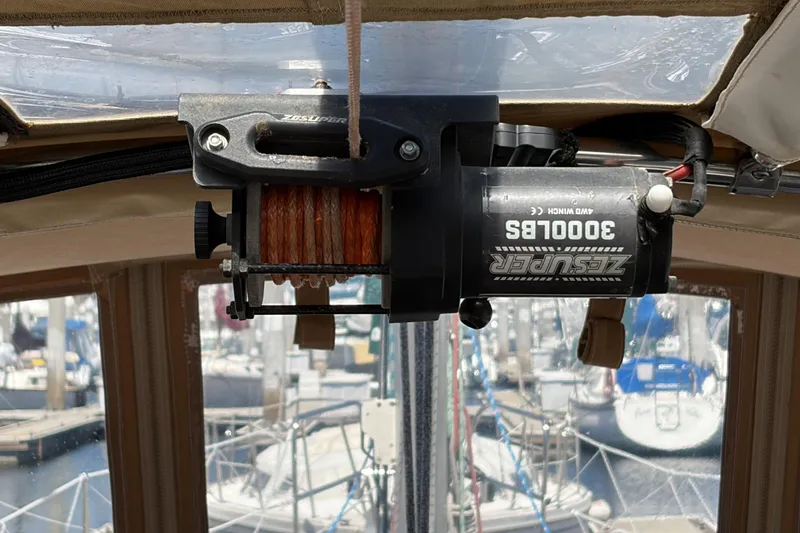 Electric winch on a 2010 Beneteau Oceanis 37 sailboat, docked at a marina.