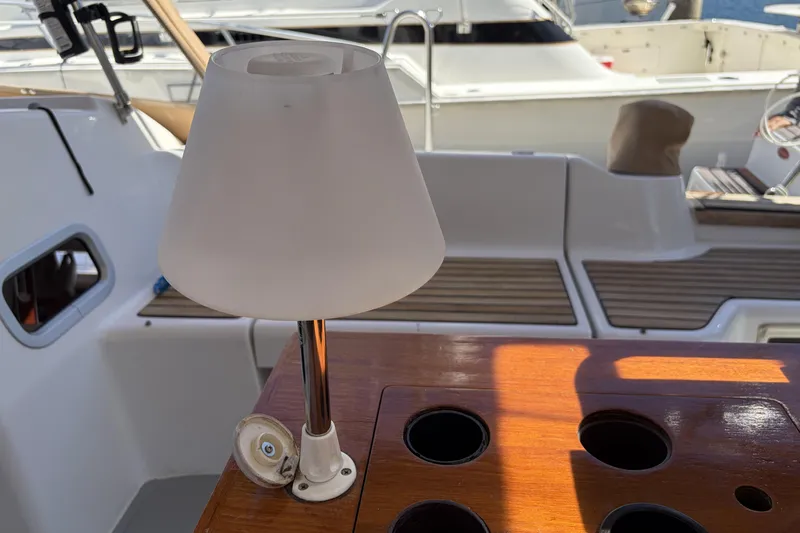 Lamp on Beneteau Oceanis 37 yacht's wooden deck, 2010 model, with cup holders.