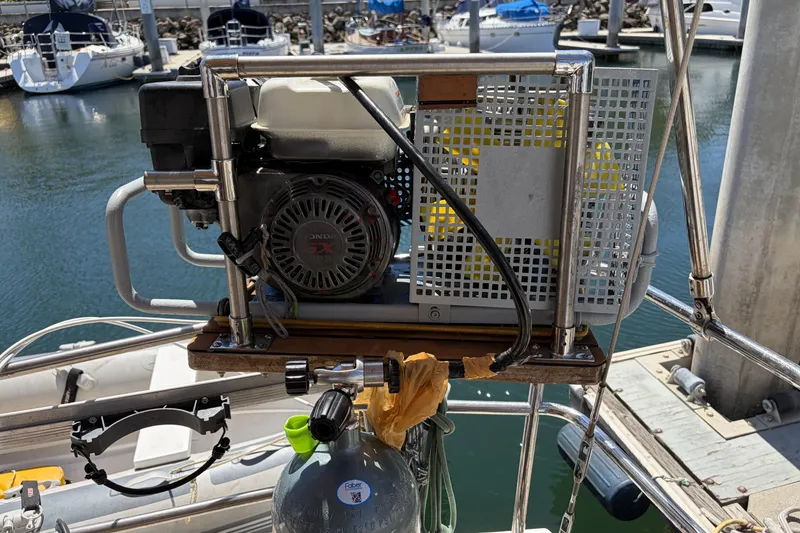 Portable compressor on a 2010 Beneteau Oceanis 37 sailboat at a marina.