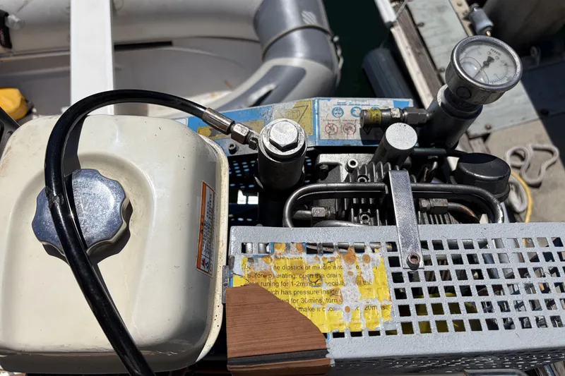 Close-up of a Beneteau Oceanis 37 engine component, featuring gauges and hoses, 2010 model.