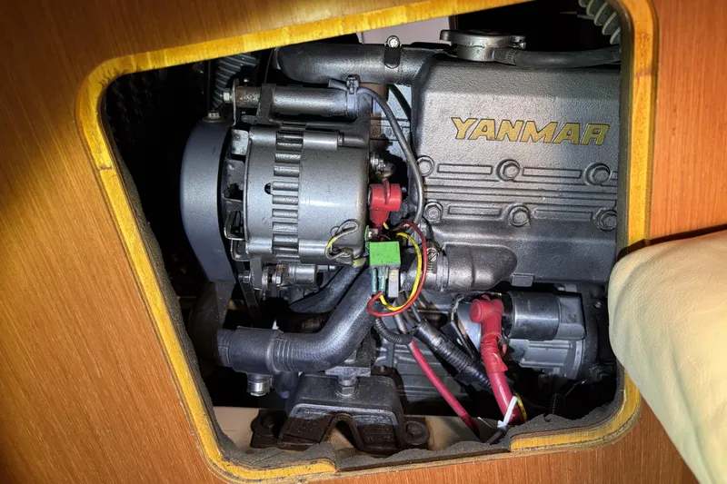 Yanmar engine inside a 2010 Beneteau Oceanis 37 sailboat, showcasing mechanical components.